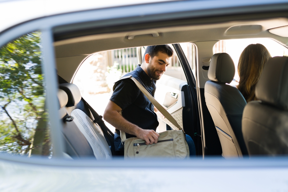 A man gets into a rideshare vehicle