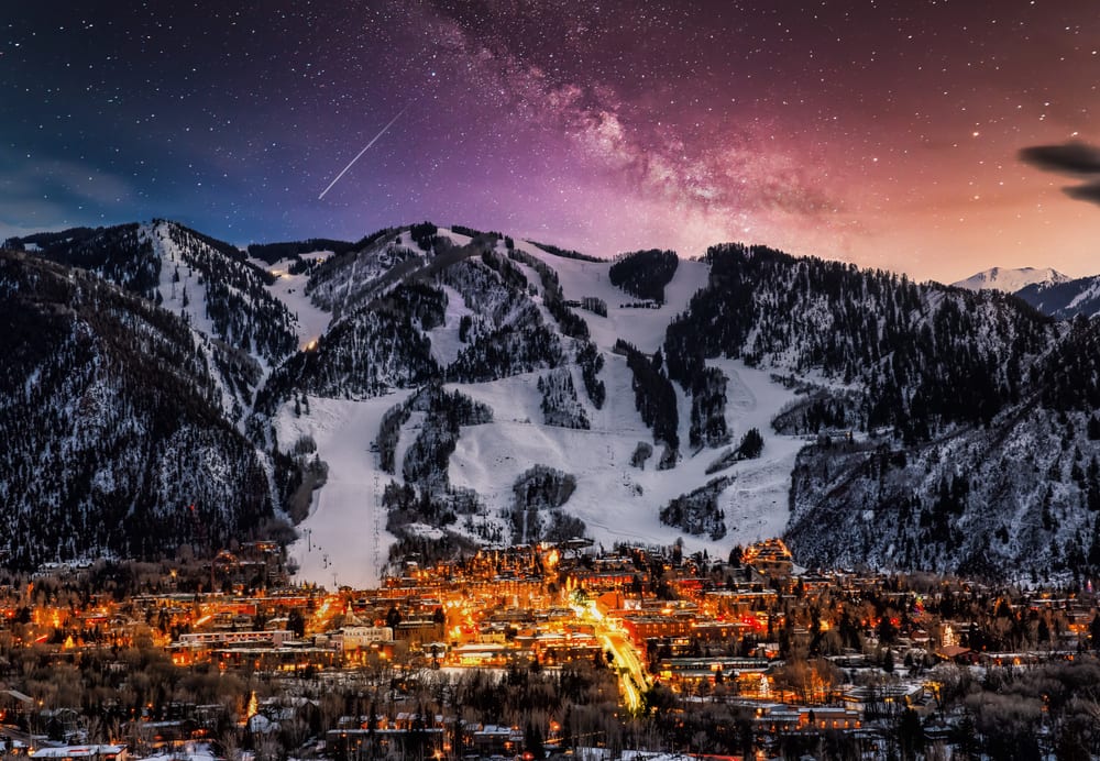 Evening in Aspen Colorado is shown with snow covered mountains