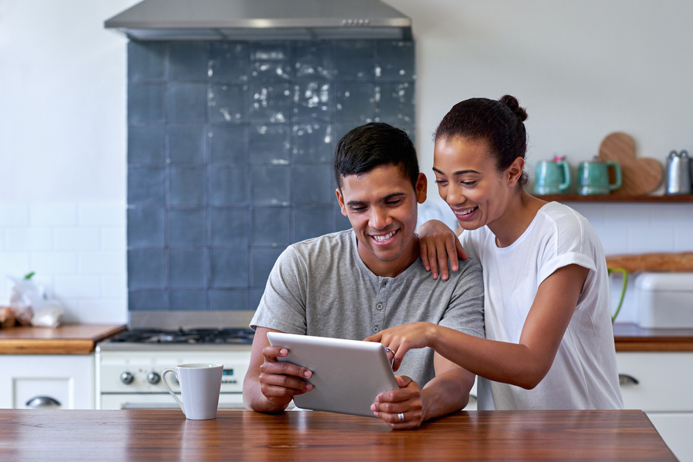 Couple checking high interest rate on iPad